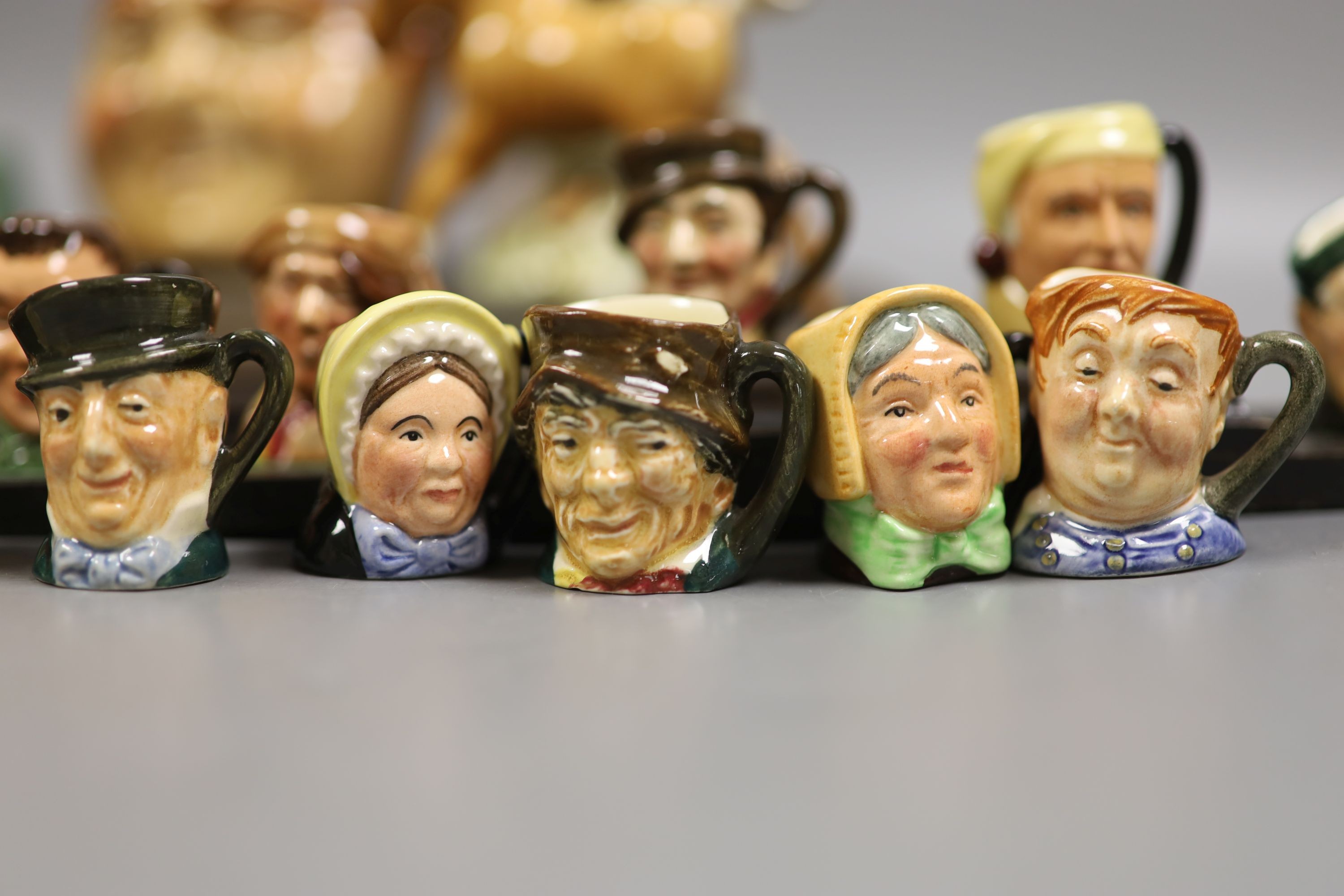 A collection of Royal Doulton miniature character mugs, figurines, series plate etc